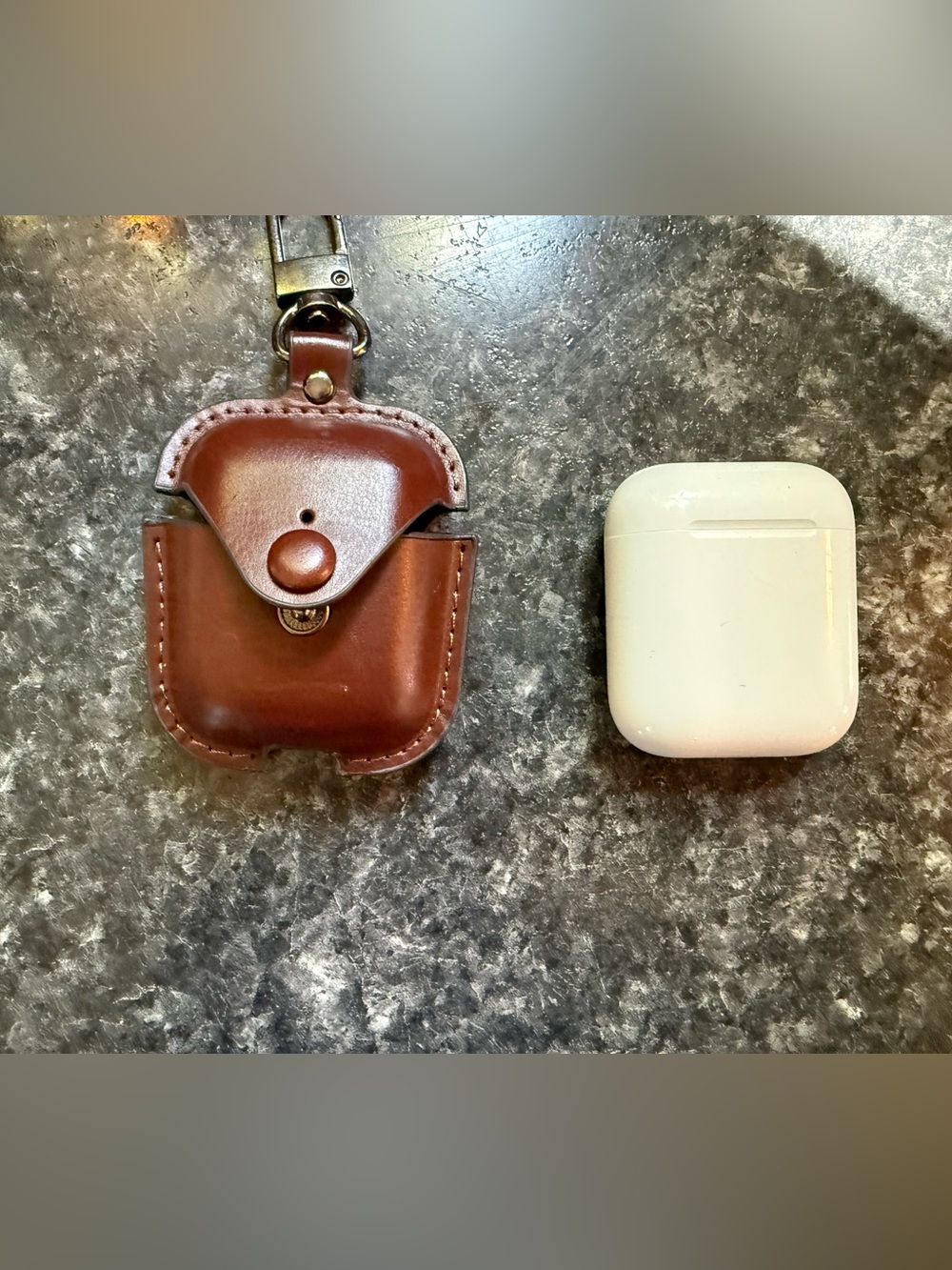 Apple AirPods and brown leather case